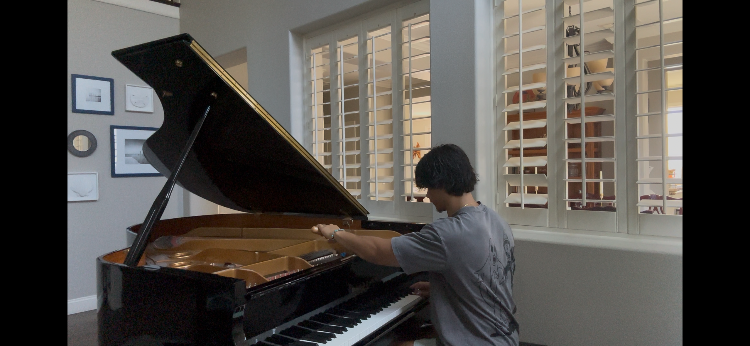 Piano technician working inside a grand piano